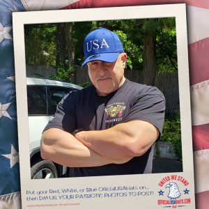 Guy wearing blue USA hat with large arms crossed