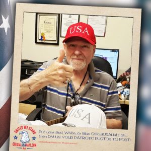 Veteran giving thumbs up wearing Red Official USA hat