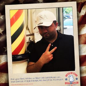 Fun barber wearing a white Official USA Hat flipping the peace sign
